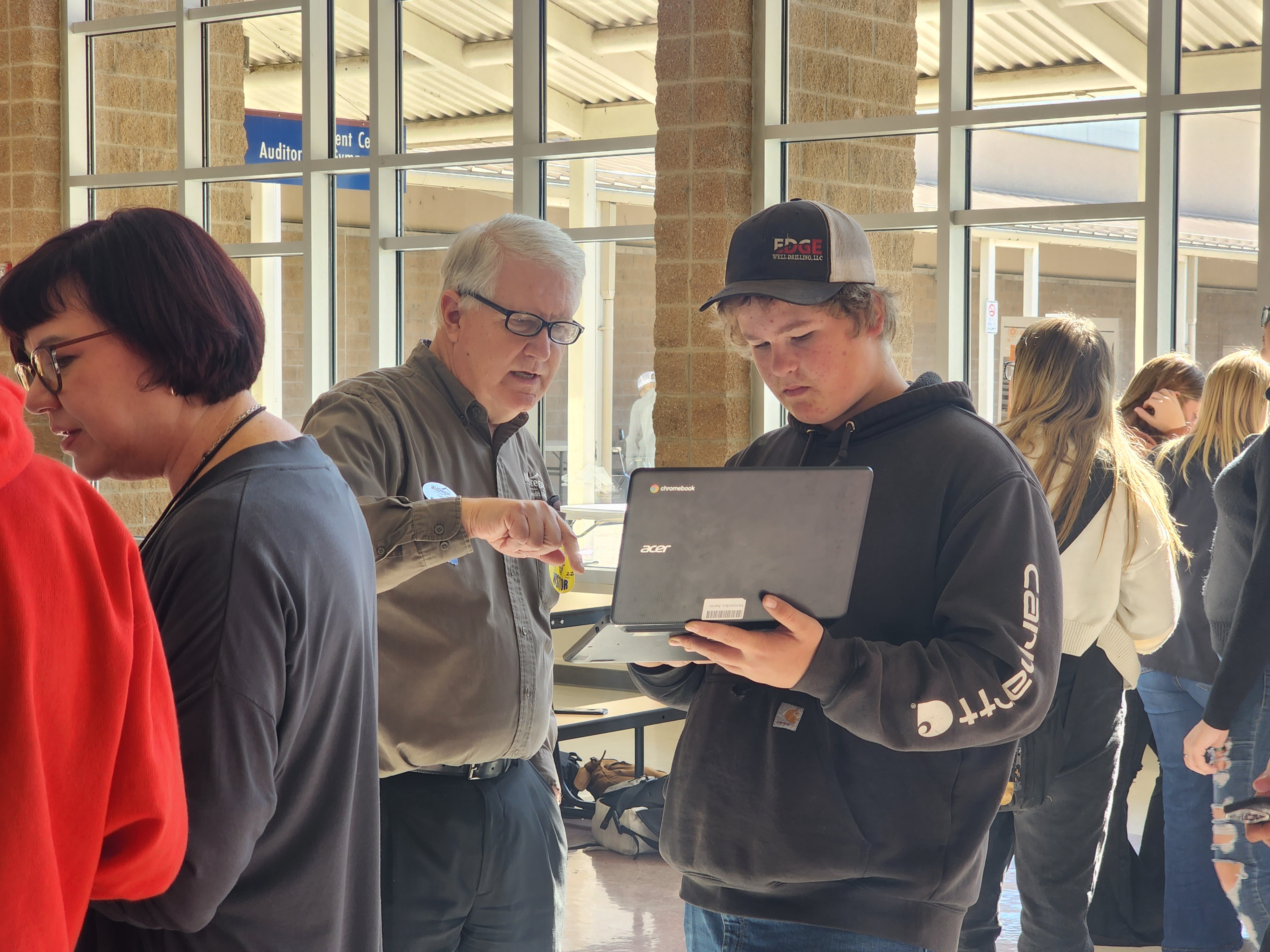 Mid Oregon team members work with students from Crook County High School during a Bite of Reality budgeting simulation